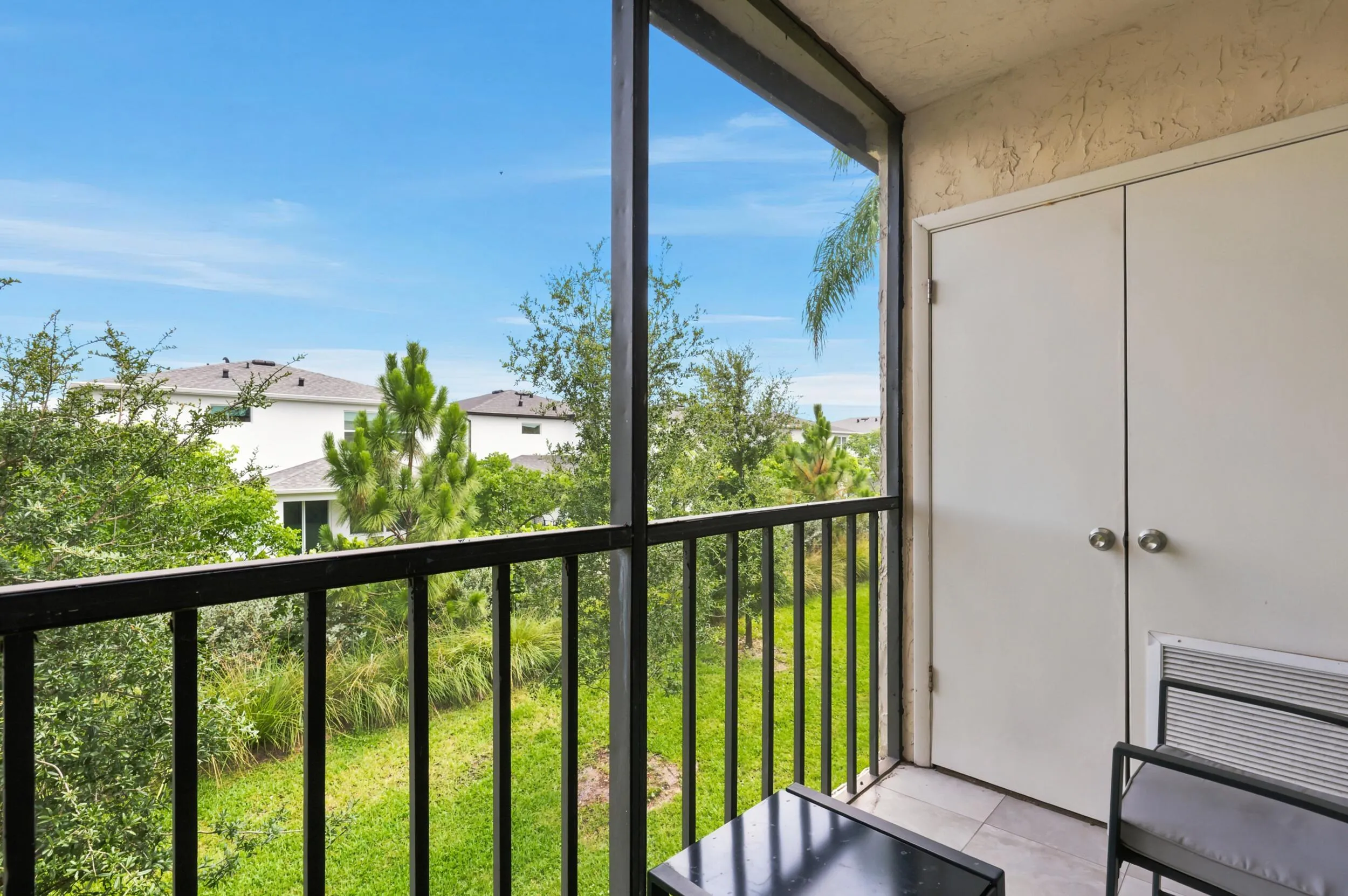Enjoy your own private outdoor retreat from this screened balcony overlooking lush green space and mature tropical landscaping. Accessible directly from the living area, this inviting space is perfect for morning coffee, evening relaxation, or simply enjoying the peaceful surroundings and year-round South Florida weather. The screened enclosure provides added comfort while preserving the tranquil garden views below.