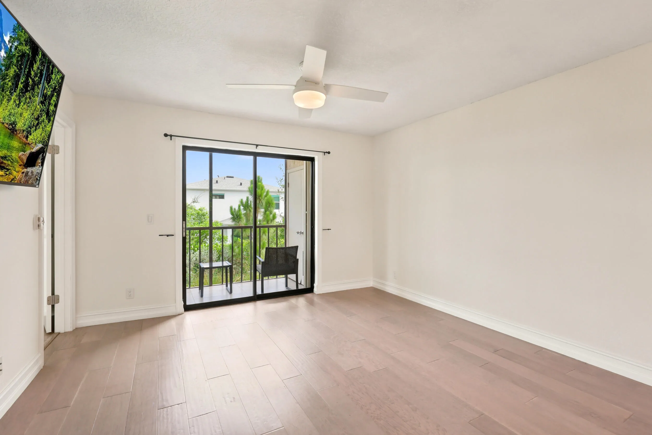 The spacious living area offers an open and versatile layout designed for comfortable everyday living and entertaining. Updated flooring flows throughout the space, while large sliding glass doors fill the room with natural light and provide seamless access to the private screened balcony. The open-concept design connects effortlessly to the kitchen and dining areas, creating a bright and inviting atmosphere throughout the home.