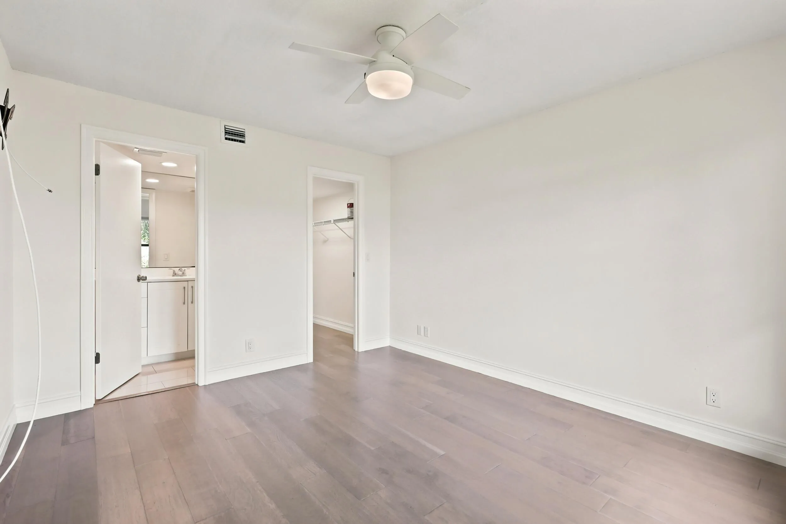 The spacious primary suite offers a peaceful retreat with updated flooring, abundant natural light, and a clean, modern aesthetic. A generous walk-in closet provides excellent storage, while the private ensuite bath adds convenience and functionality. The comfortable layout creates the perfect space to relax and unwind at the end of the day.