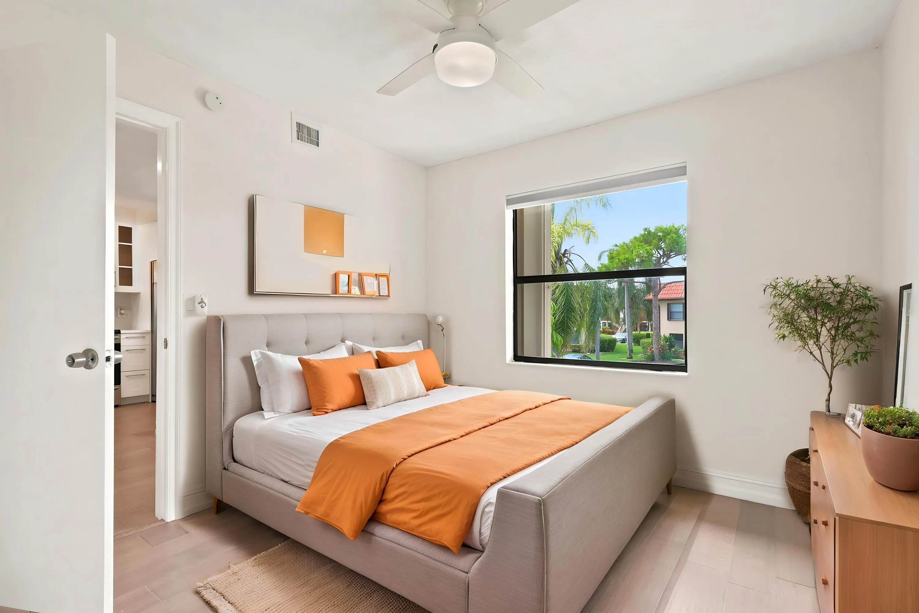 Bright and comfortable, the guest bedroom features updated flooring, generous closet space, and a large window that brings in plenty of natural light while overlooking the community's beautifully maintained grounds. The versatile layout is ideal for guests, a home office, or additional living space, offering both comfort and flexibility.