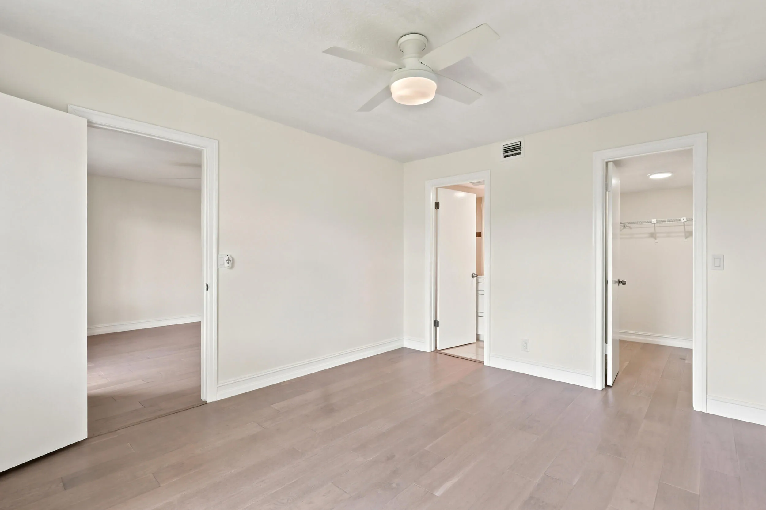 The spacious primary suite offers a peaceful retreat with updated flooring, abundant natural light, and a clean, modern aesthetic. A generous walk-in closet provides excellent storage, while the private ensuite bath adds convenience and functionality. The comfortable layout creates the perfect space to relax and unwind at the end of the day.