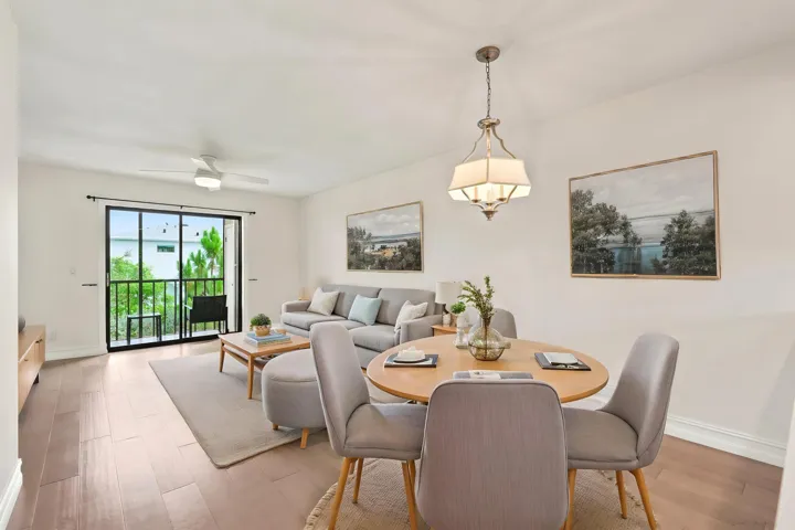 The spacious living area offers an open and versatile layout designed for comfortable everyday living and entertaining. Updated flooring flows throughout the space, while large sliding glass doors fill the room with natural light and provide seamless access to the private screened balcony. The open-concept design connects effortlessly to the kitchen and dining areas, creating a bright and inviting atmosphere throughout the home.
