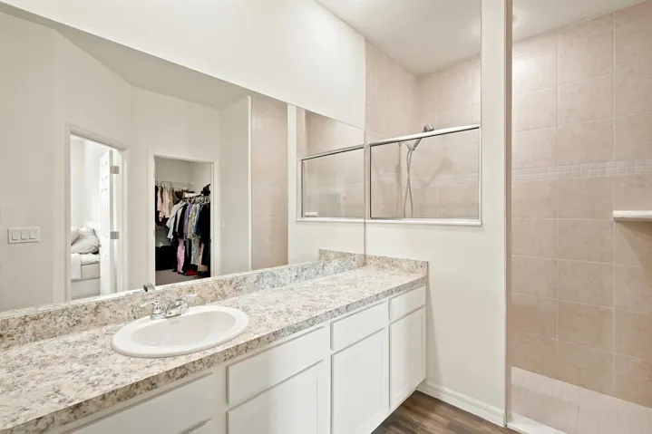 Spacious bathroom with tiled shower