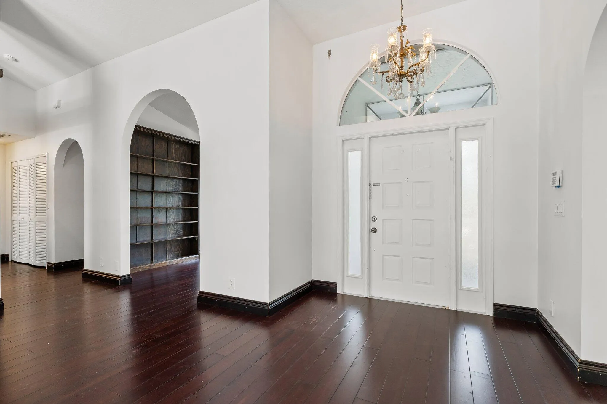 Foyer with hardwood floors and chandelier