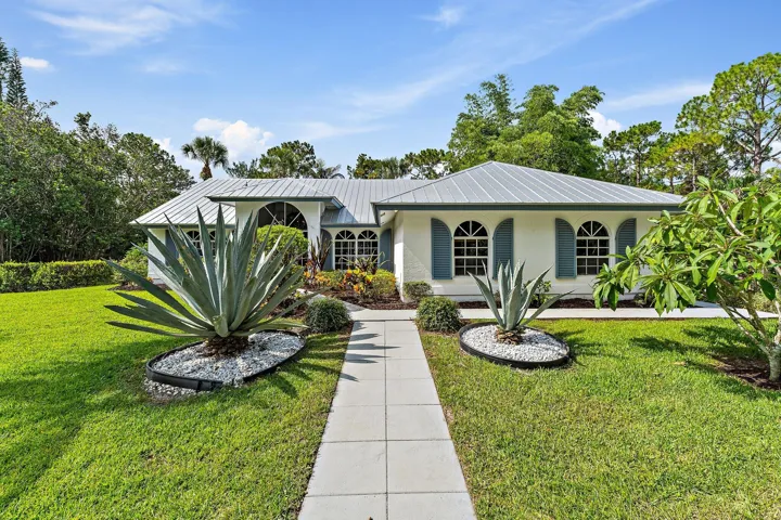 Front exterior with metal roof and arched windows