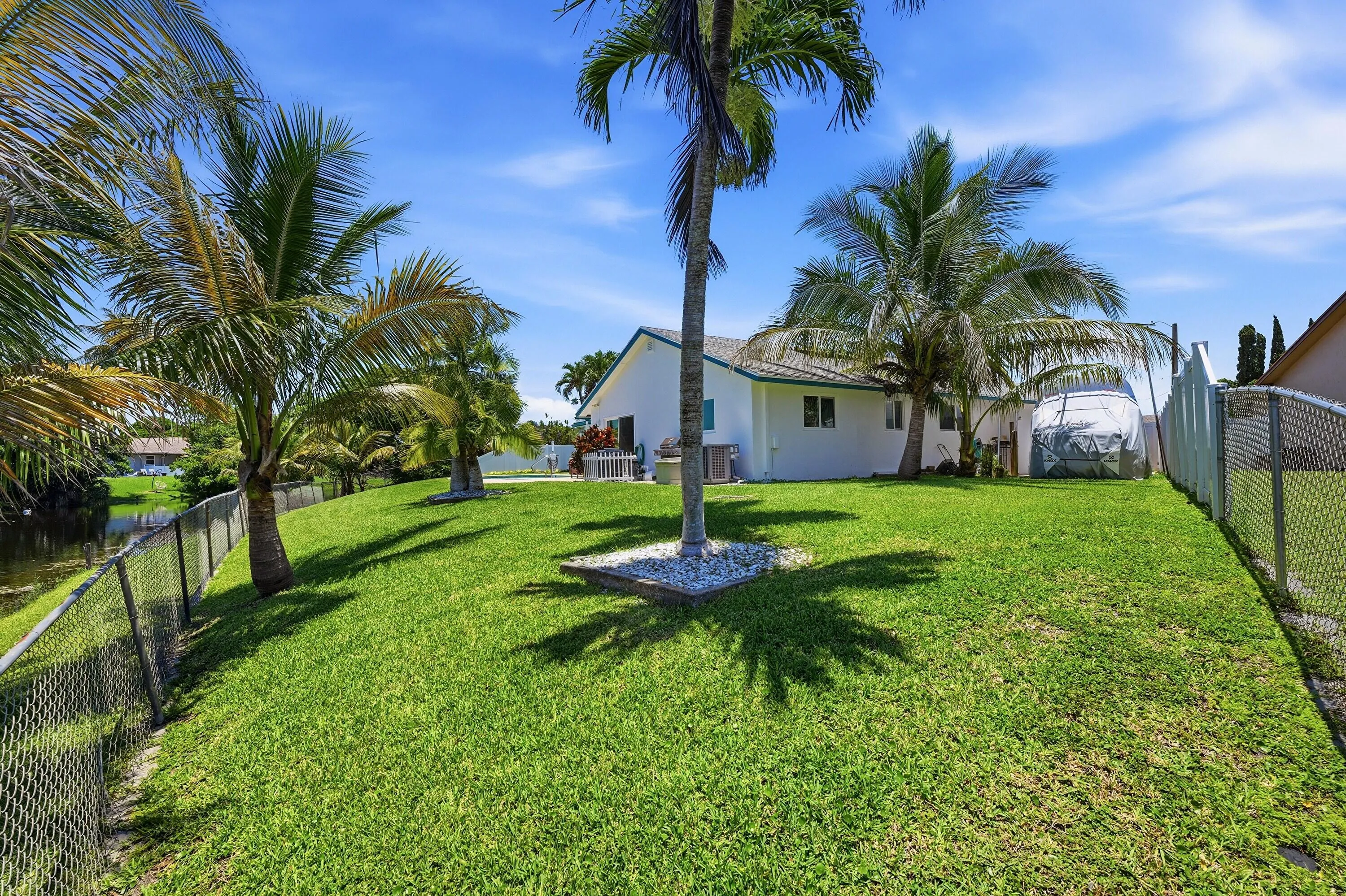 Fully fenced back yard with city compliant RV/Boat storage on side of house.