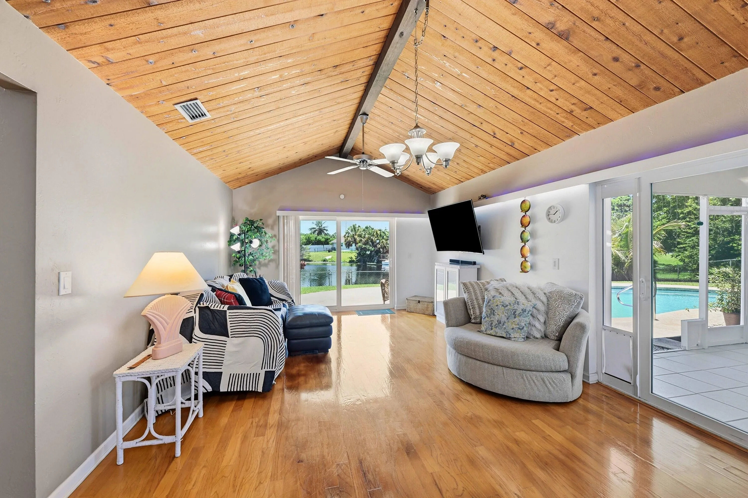 Den with expansive water views and access to patio/backyard