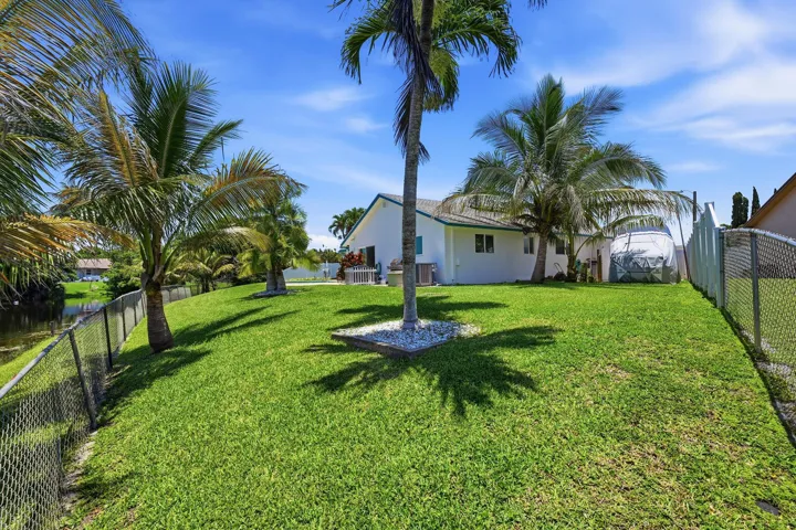Fully fenced back yard with city compliant RV/Boat storage on side of house.