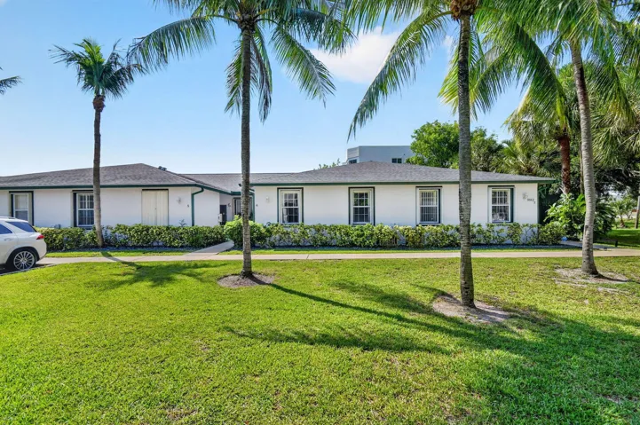 Large grassy area in front of villa