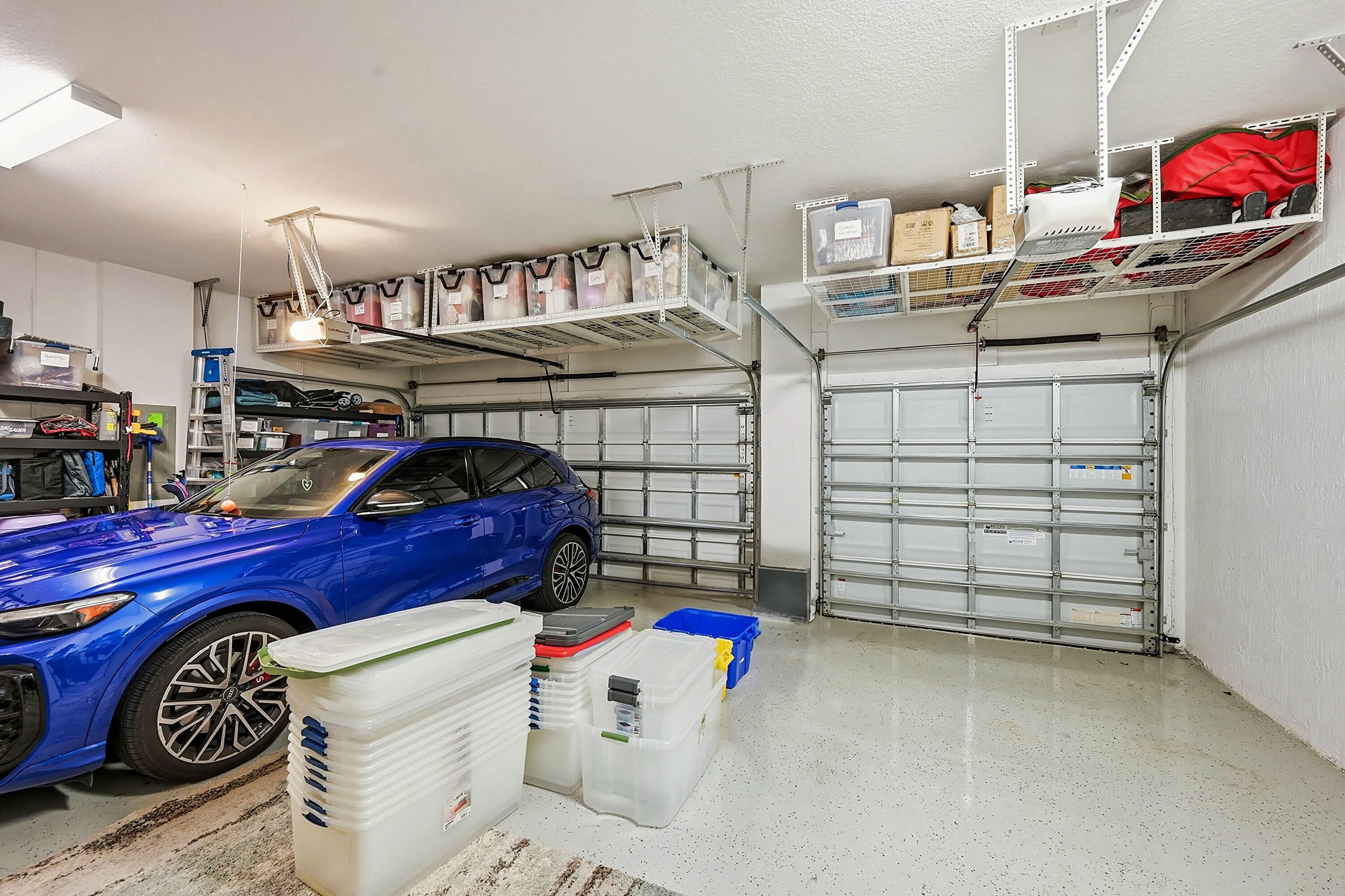 3 car garage with lots of strage racks above.