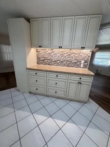 The dining area is open to the living room. and the kitchen.