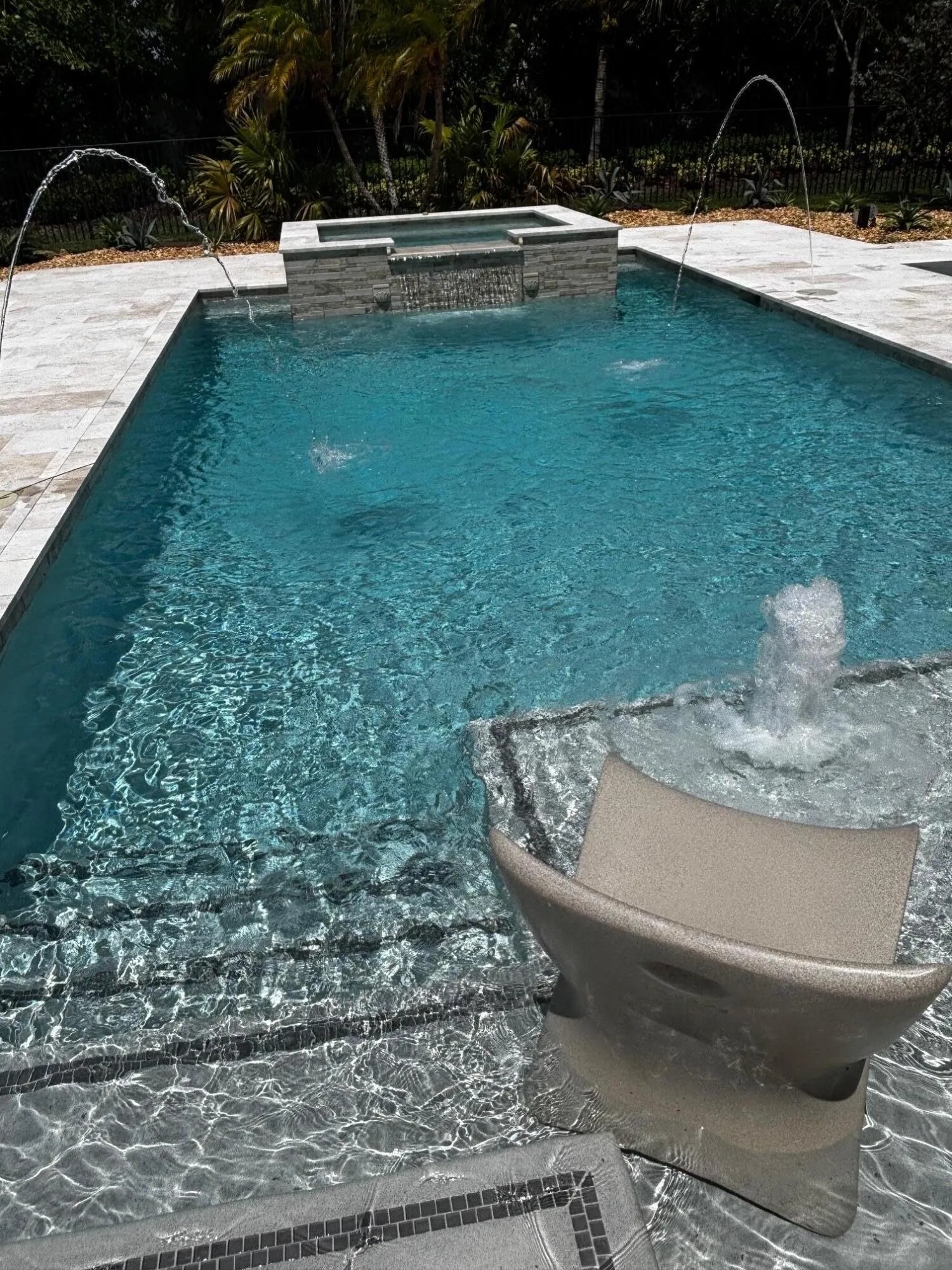 Pool with fountains and chairs