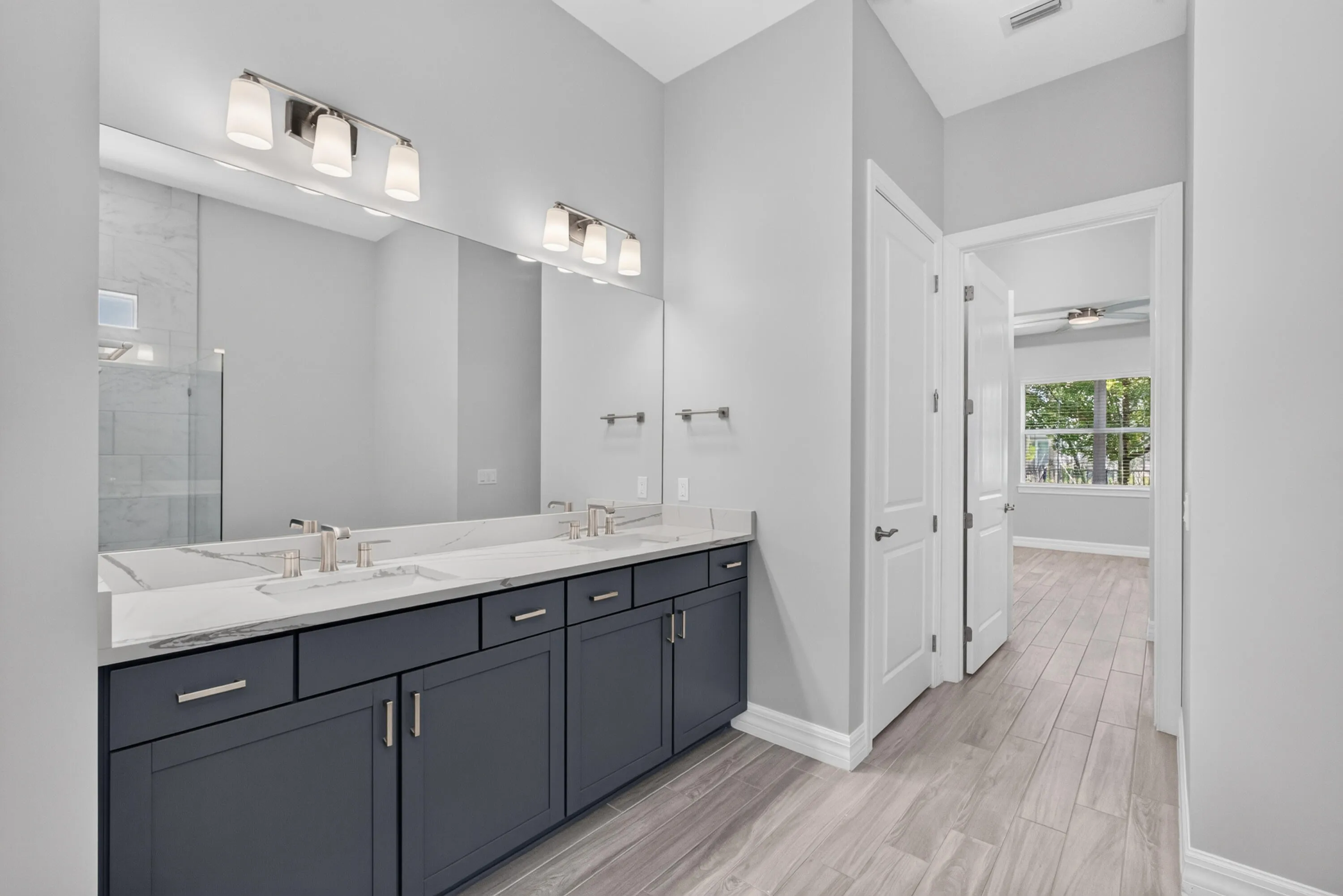The primary bath is appointed with dual vanities, a private water closet, and generous storage.