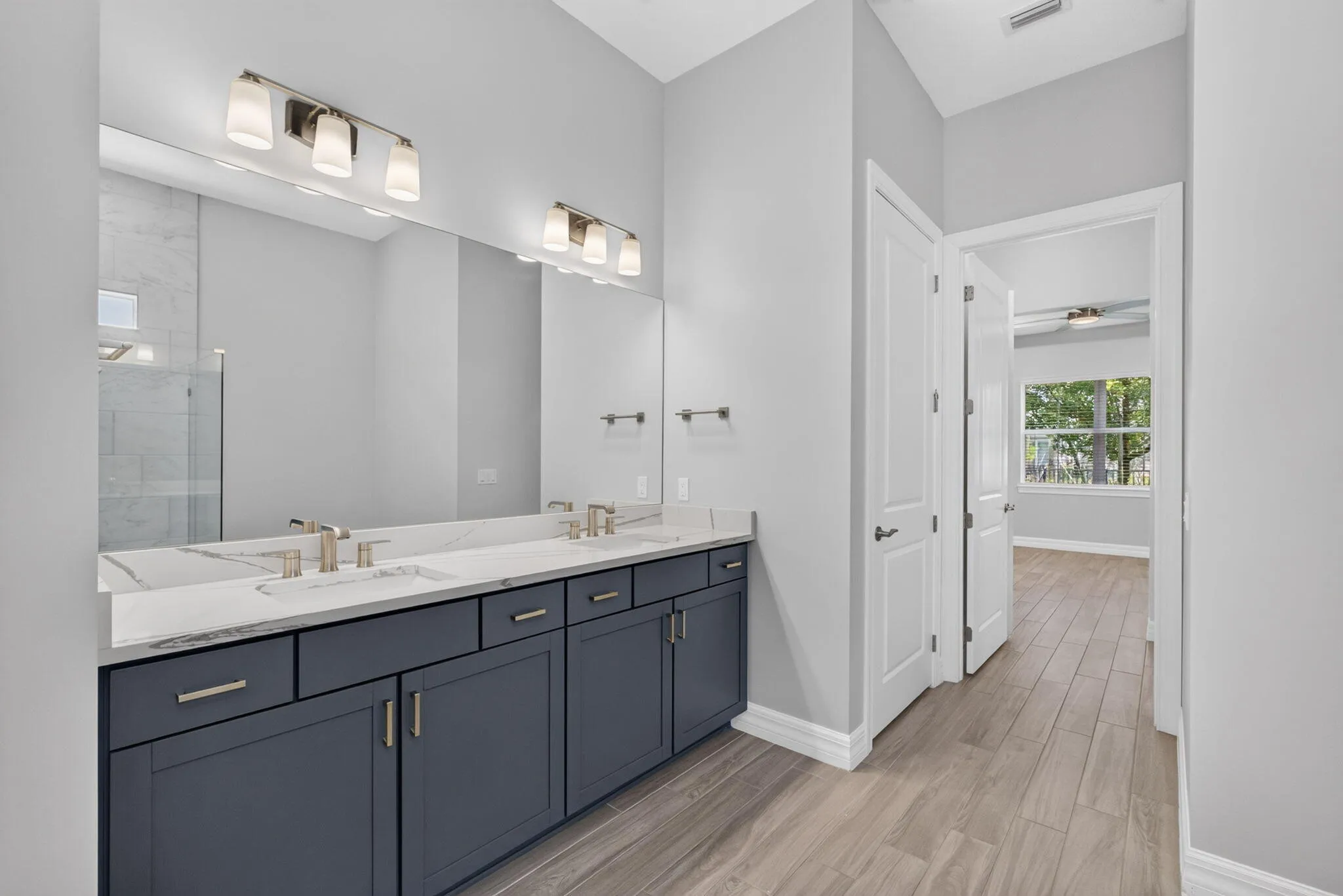 The primary bath is appointed with dual vanities, a private water closet, and generous storage.