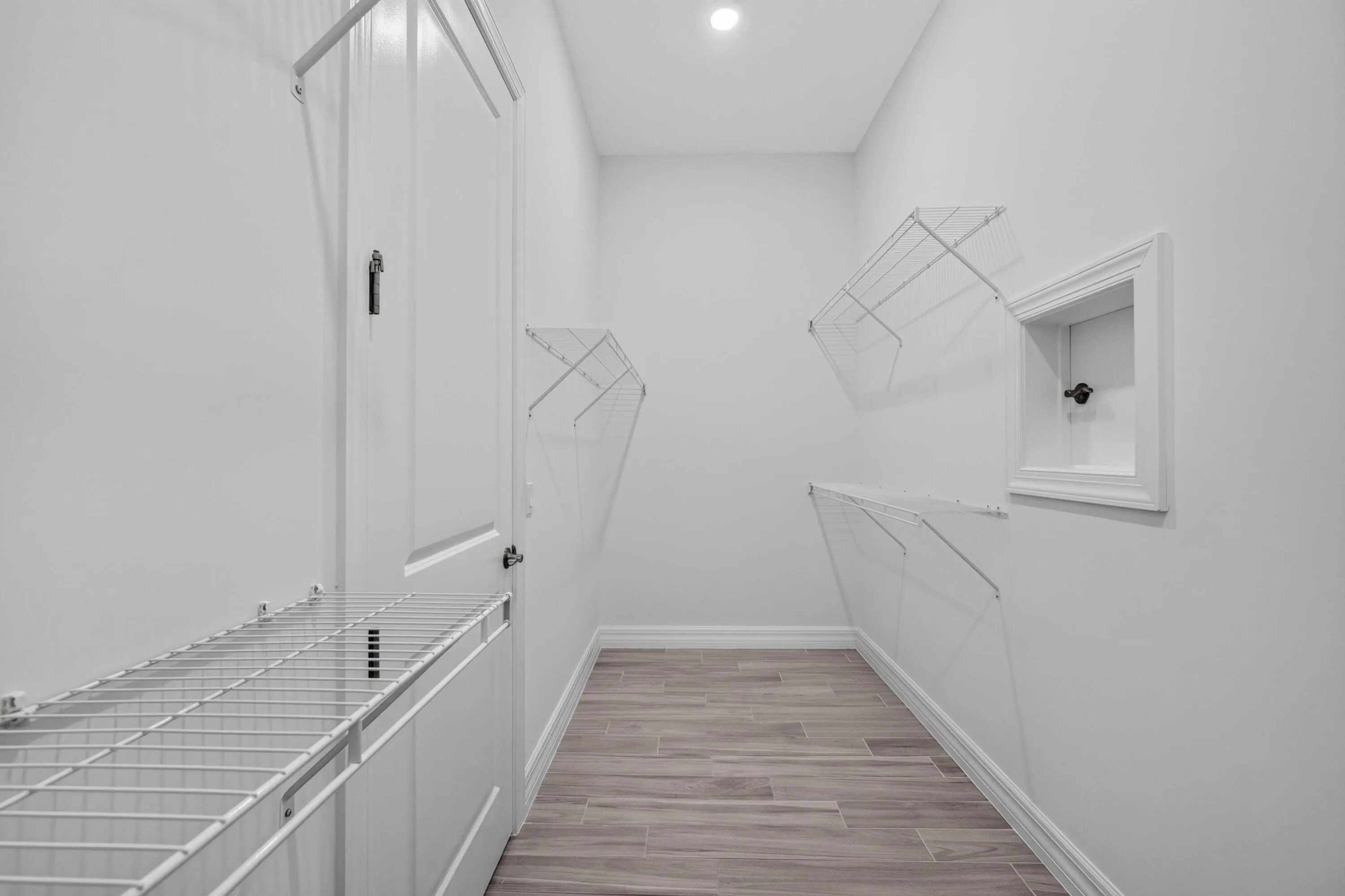 The secondary primary walk-in closet features a thoughtfully designed pass-through door providing direct access to the laundry room for added convenience and functionality.