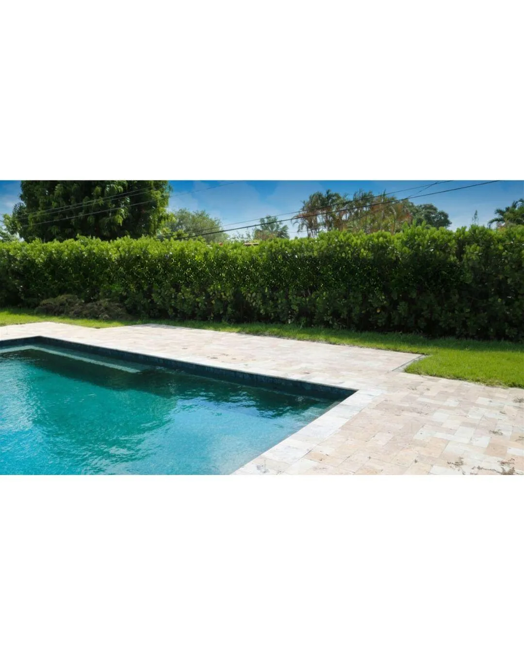 POOL WITH LOUNGE CHAIR AREARelax poolside in the heated saltwater pool surrounded by ample lounging space, perfect for entertaining guests or enjoying the Florida sunshine year-round. Wilton Manors home for sale, heated saltwater pool, smart home, vacation rental, South Florida living, move-in ready home, pool home, luxury primary suite, chef's kitchen, energy-efficient home.