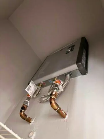 TANKLESS WATER HEATEREnjoy virtually endless hot water with the home's high-efficiency tankless water heating system, designed for comfort and energy savings. Wilton Manors home for sale, heated saltwater pool, smart home, vacation rental, South Florida living, move-in ready home, pool home, luxury primary suite, chef's kitchen, energy-efficient home.