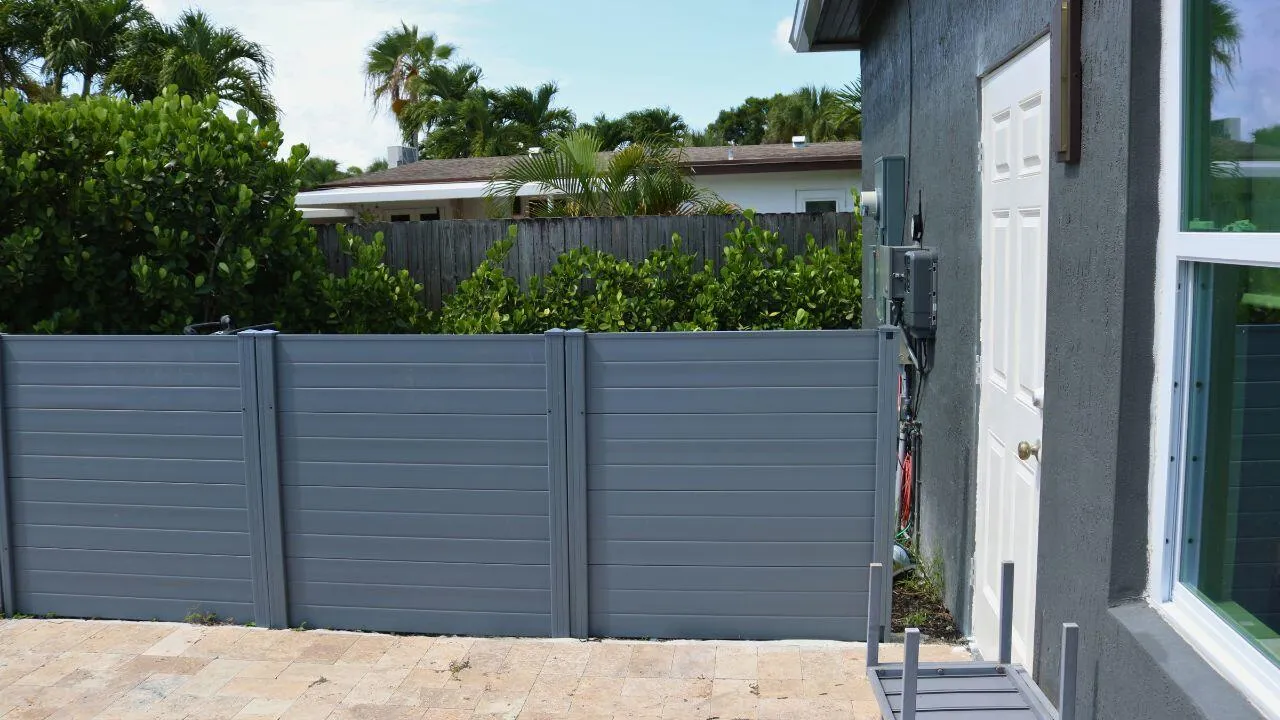 POOL EQUIPMENT AREAPool equipment is thoughtfully positioned behind a fenced enclosure, maintaining a clean and attractive backyard appearance. Wilton Manors home for sale, heated saltwater pool, smart home, vacation rental, South Florida living, move-in ready home, pool home, luxury primary suite, chef's kitchen, energy-efficient home.