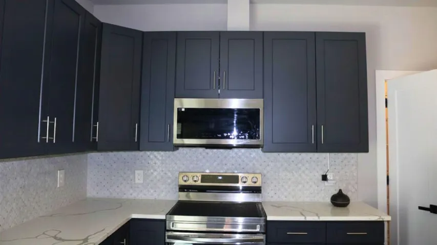 OVEN & MICROWAVE VIEWModern stainless appliances, including built-in microwave and oven, provide style, efficiency, and convenience for home chefs.Wilton Manors home for sale, heated saltwater pool, smart home, vacation rental, South Florida living, move-in ready home, pool home, luxury primary suite, chef's kitchen, energy-efficient home.