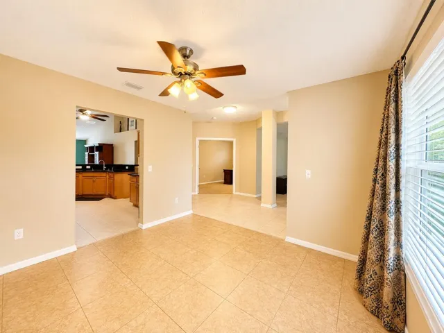 view in dining area looking into foyer and kitchen entrance