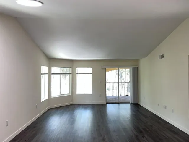 Living Room with bay window and sliding door- wood vinyl floor and newly painted
