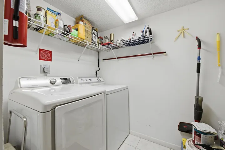 Laundry room with full size washer/dryer plus storage space