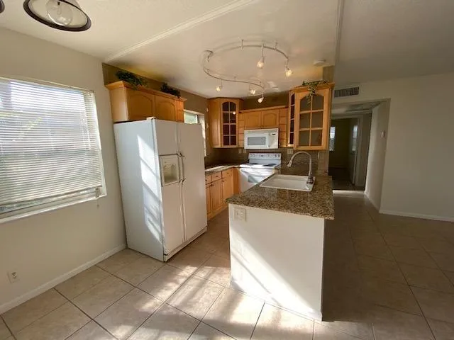 Kitchen with granite island & wood cabinets