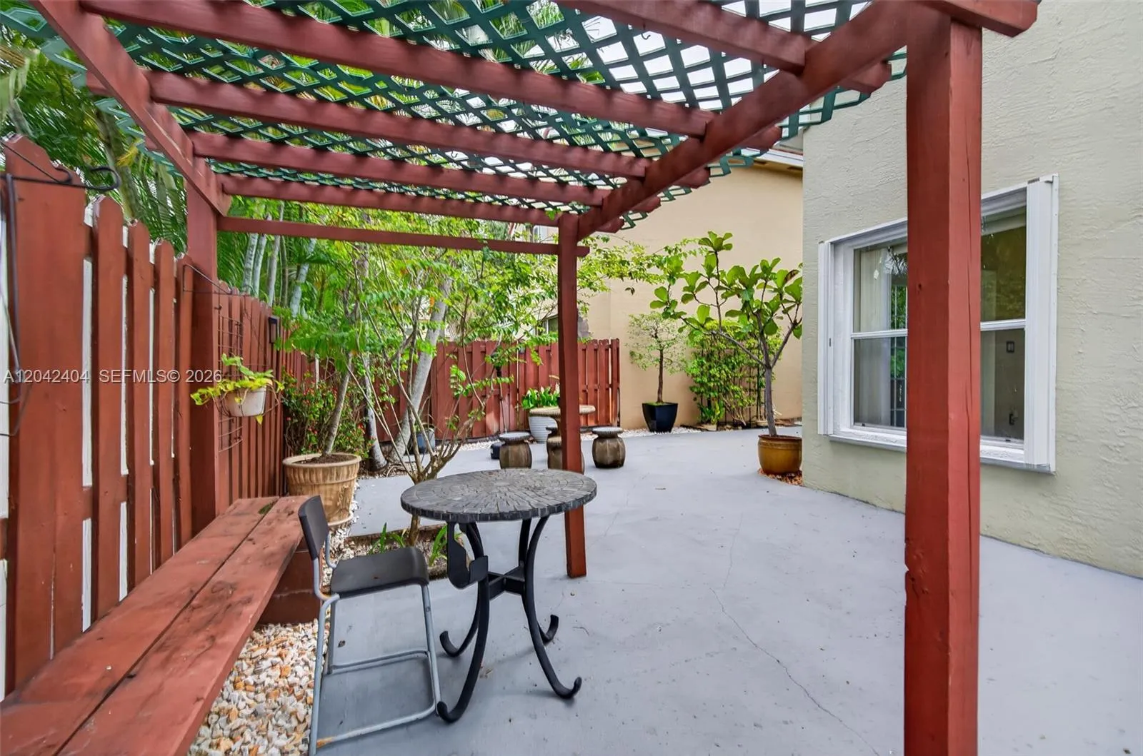Lovely pergola is perfect for hanging orchids or other plants.