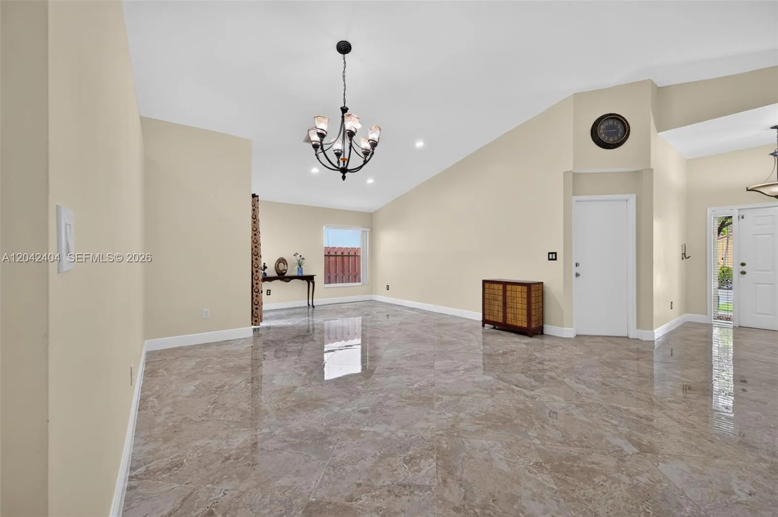 Formal living room and dining room with soaring volume ceilings.