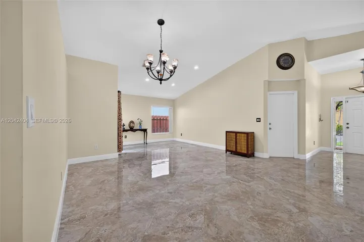 Formal living room and dining room with soaring volume ceilings.