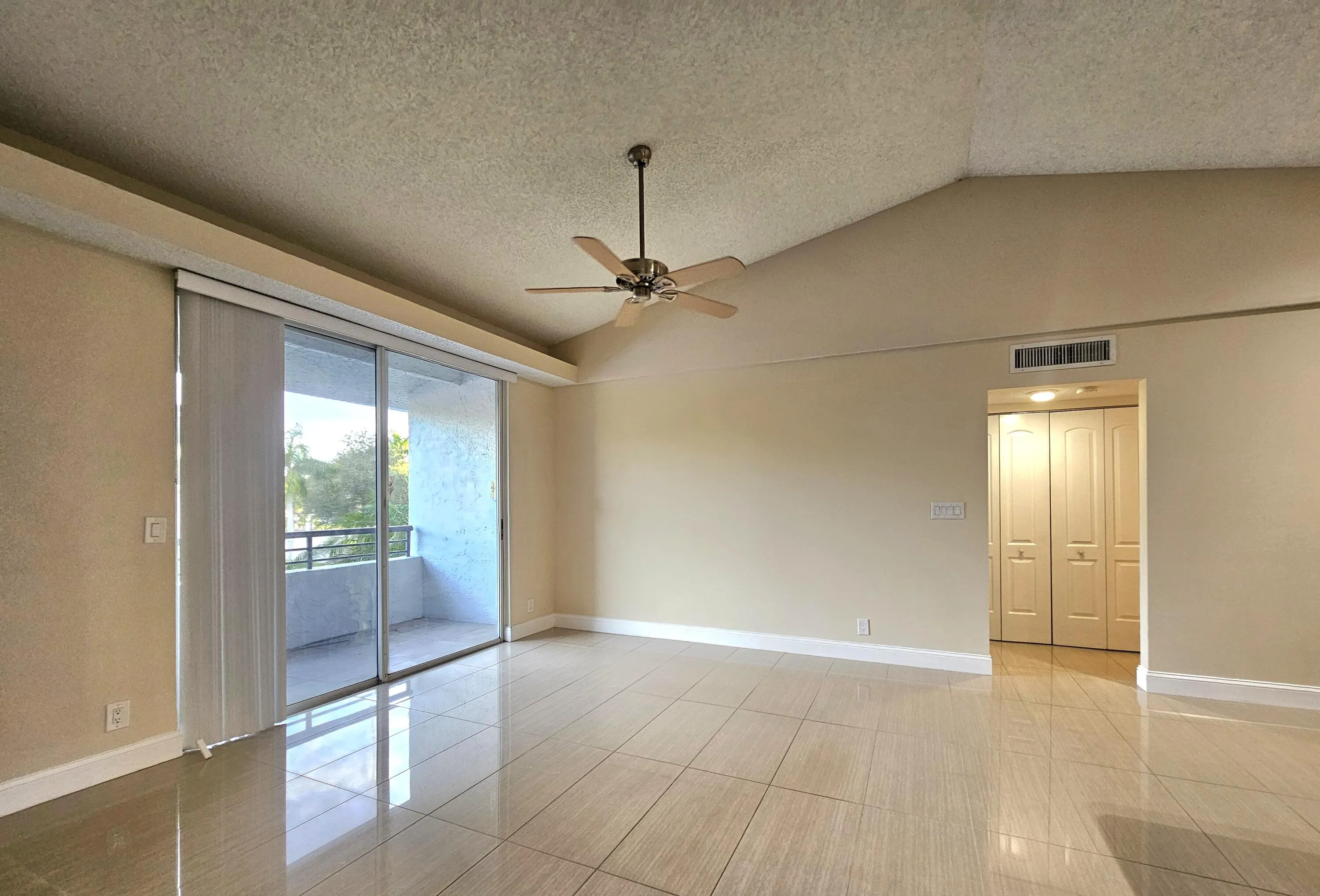 SLIDING GLASS DOORS LEADING OUT TO YOUR PRIVATE BALCONY AND THE ENTRANCE WAY TO YOUR BEDROOM, BATHROOM AND LAUNDRY CLOSET.
