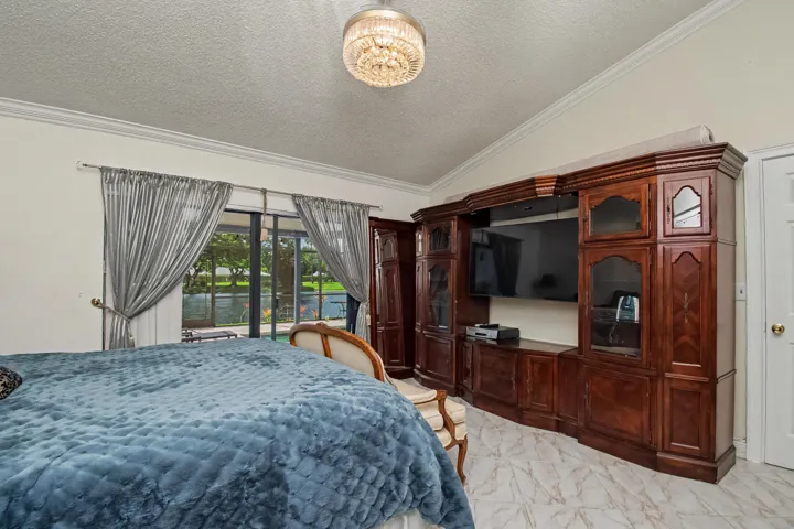 Your own sliding glass door overlooking your screened-in pool and lake view.
