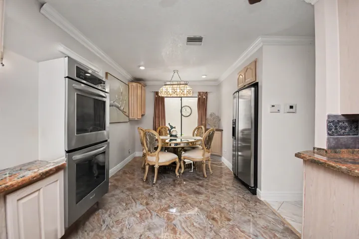 Sliding glass door from dining area in the kitchen to your own atrium courtyard. NOTE THE CABINET AROUND DOUBLE OVEN IS PHOTOSHOPPED, a custom cabinet will be installed at a later date.