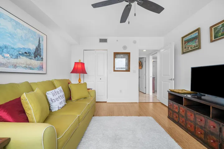 Alternate view of the guest bedroom showing bamboo flooring, closet access, and flexible layout potential.