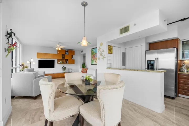Open dining area connecting naturally to the kitchen’s breakfast bar and the adjoining living space.