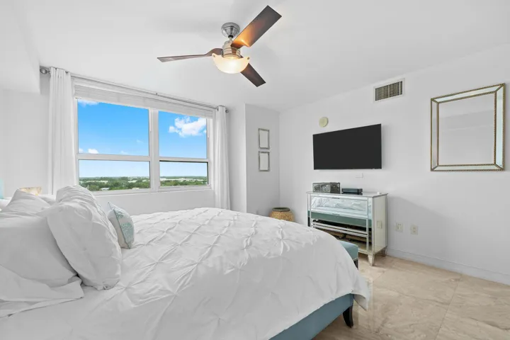 Alternate view showcasing the primary suite’s spacious proportions & marble flooring.