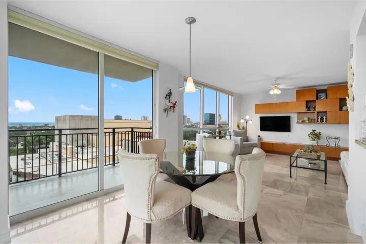 Wide view of the open living and dining areas, designed for easy entertaining and connected to the covered terrace.