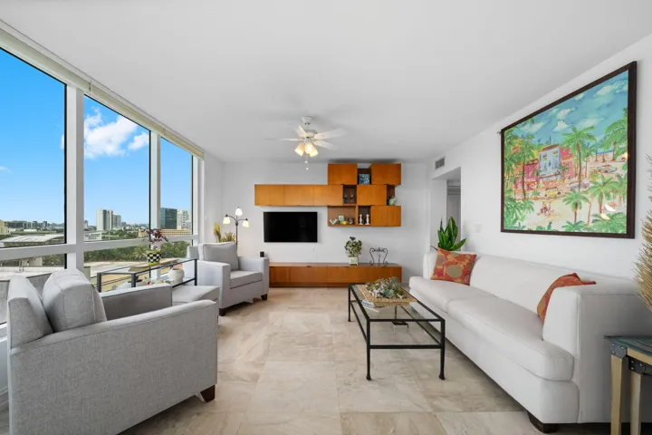 Large windows frame broad city and skyline views while filling the living room with natural light.