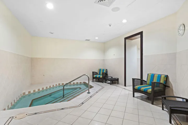 Private spa area with an indoor whirlpool and lounge seating for post-workout relaxation.