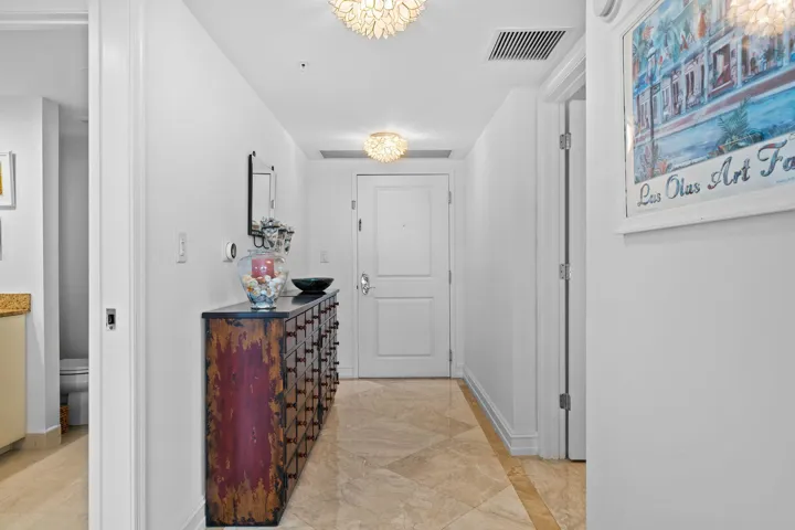 A polished marble foyer creates a warm arrival and leads into the light-filled main living areas.