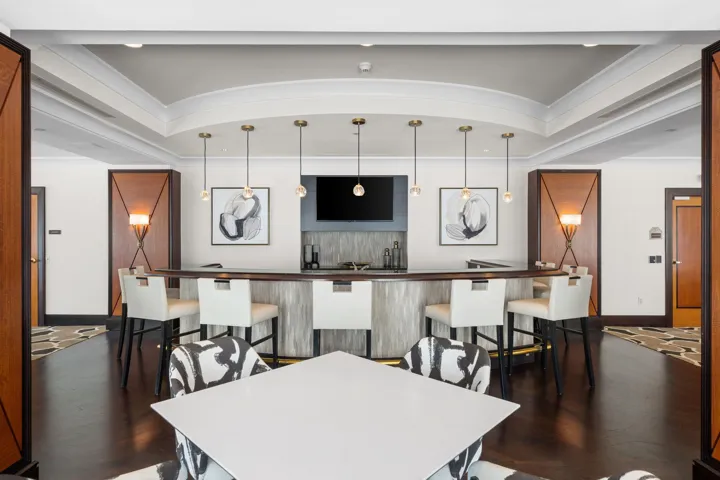Entertainment area with a full bar, generous bar seating, television, and space for hosting friends and family.