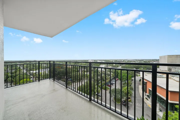 Covered wraparound terrace overlooking the surrounding Las Olas area, offering a comfortable setting for outdoor dining or relaxation.
