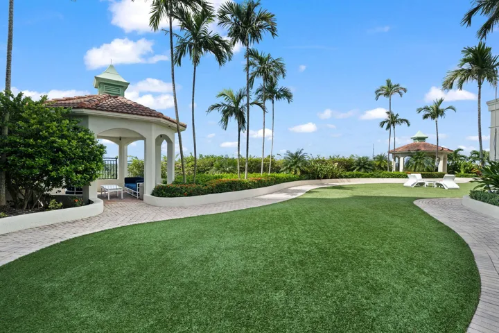 Landscaped green space with lounge chairs, walking paths, shaded gazebos, and room for private outdoor gatherings.