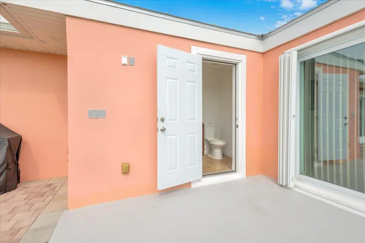 Cabana half bath entrance and slider to dining area