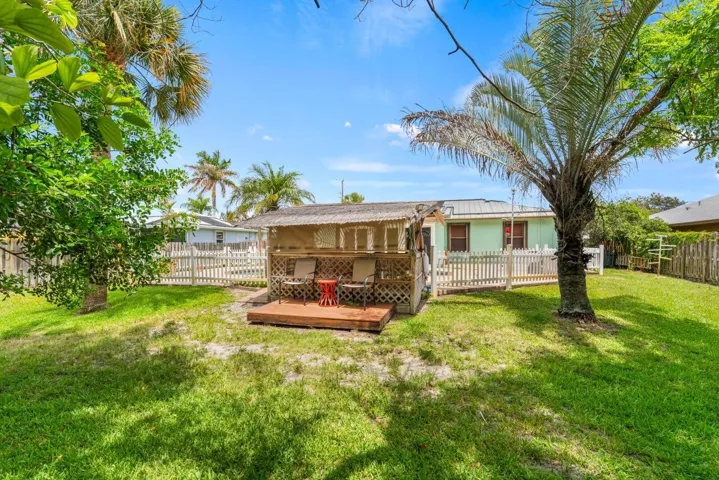 Back yard great for pets or gardening view of Tiki Bar with a small deck in the back of it,