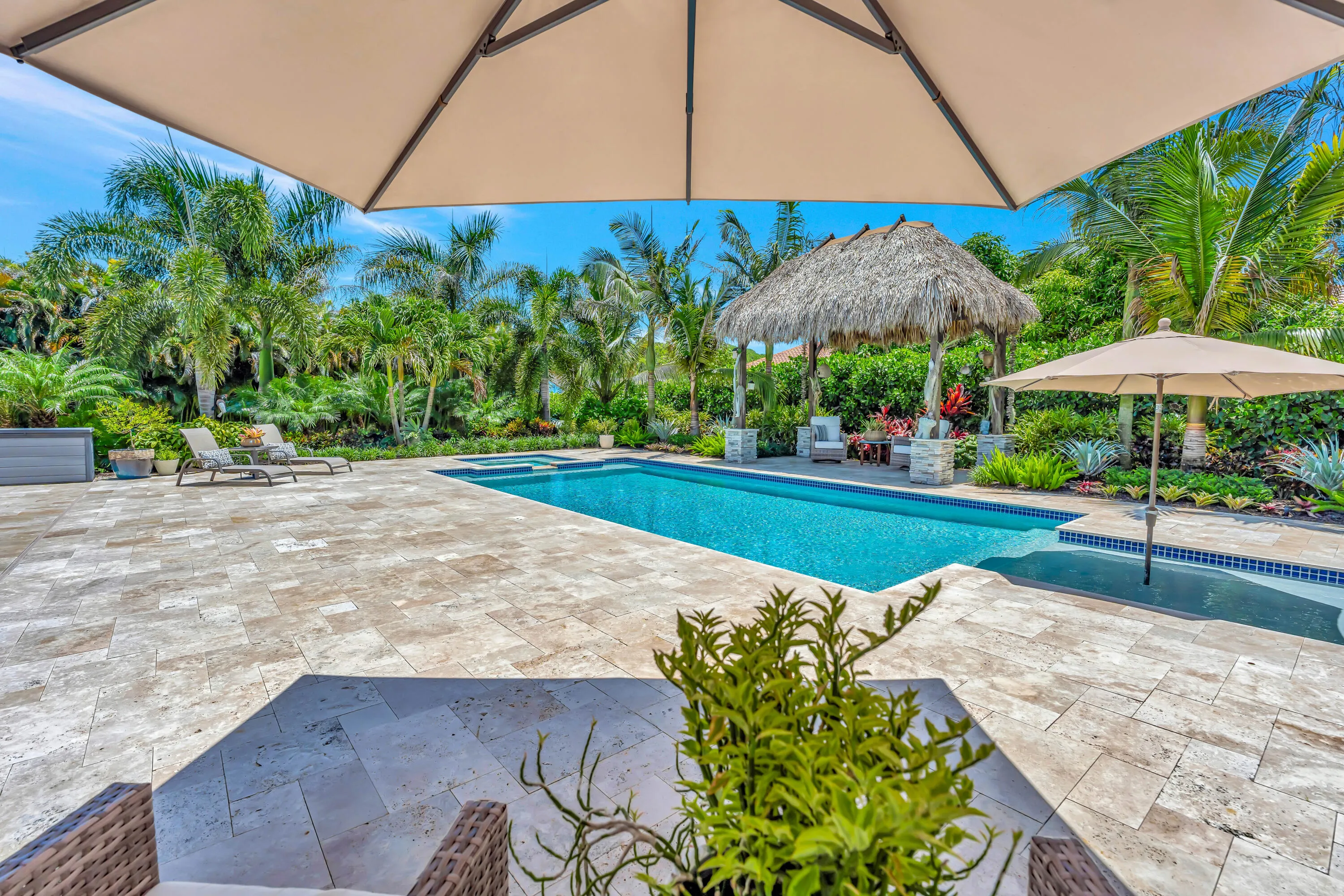 Pool tiki hut and umbrella