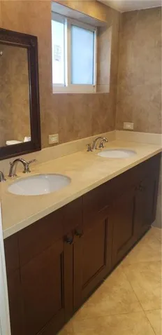 Master bathroom with double sink all tiled and granite