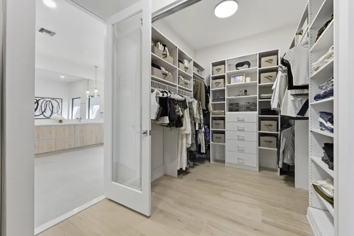 PRIMARY WALK-IN CLOSET - HERS