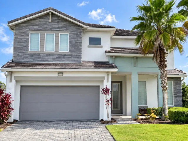 Welcome to 3870 Oakville Avenue—a fully furnished, 5-bedroom, 5-bath resort home with an inviting two-story façade, paver driveway, and tropical landscaping in gated Sonoma Resort.