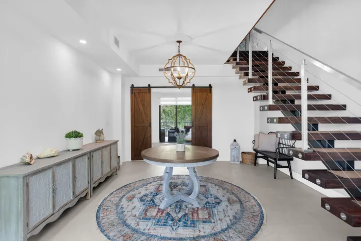 ENTRANCE FOYER LEADS TO LOWER LEVEL LIVI